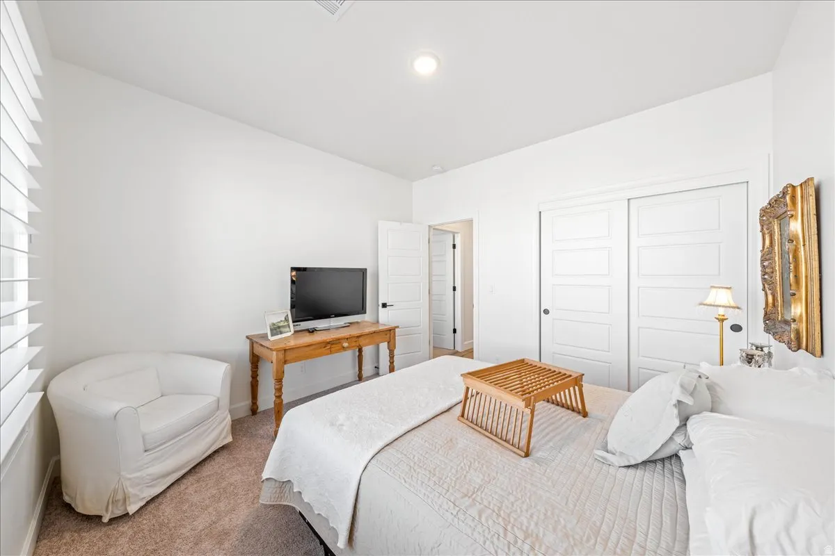 Bedroom with carpet and a closet