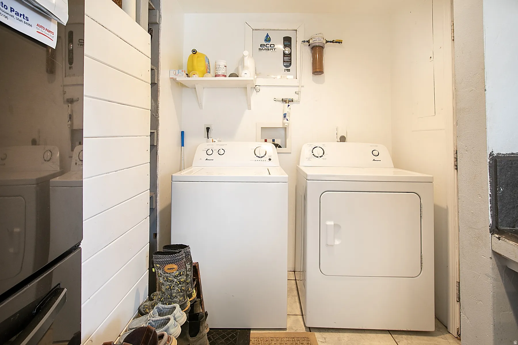 Laundry area with separate washer and dryer and light tile patterned flooring