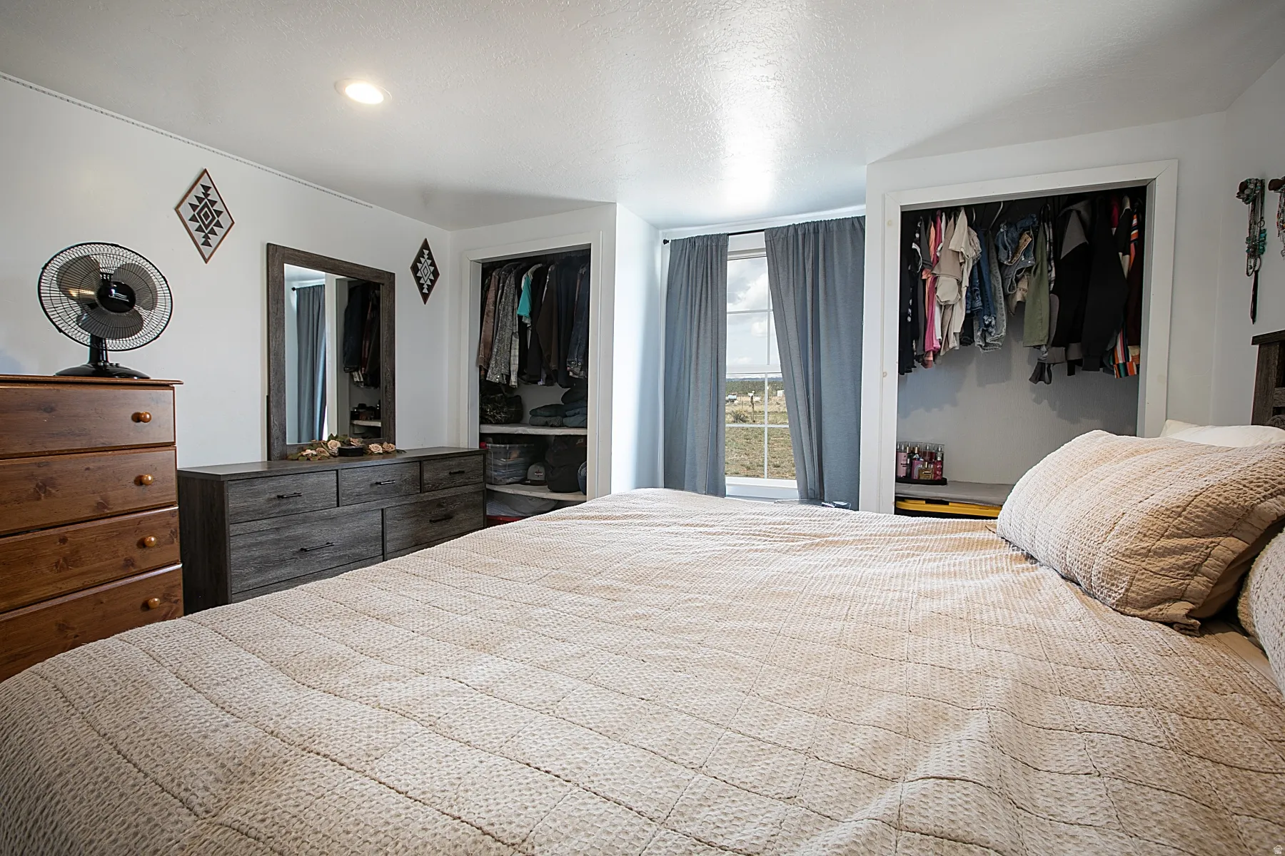 Bedroom with two closets and a textured ceiling