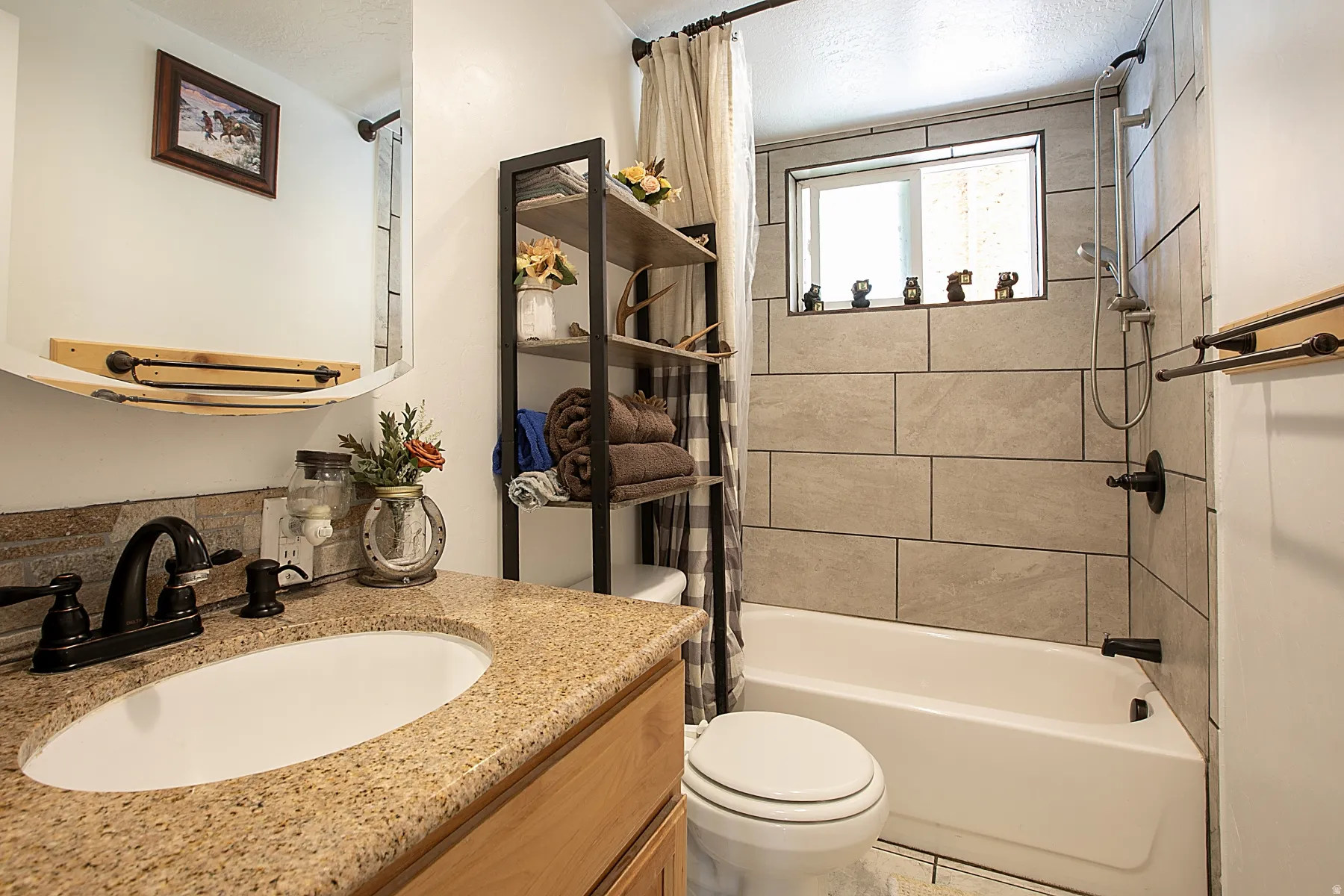 Full bath featuring vanity and shower / tub combo