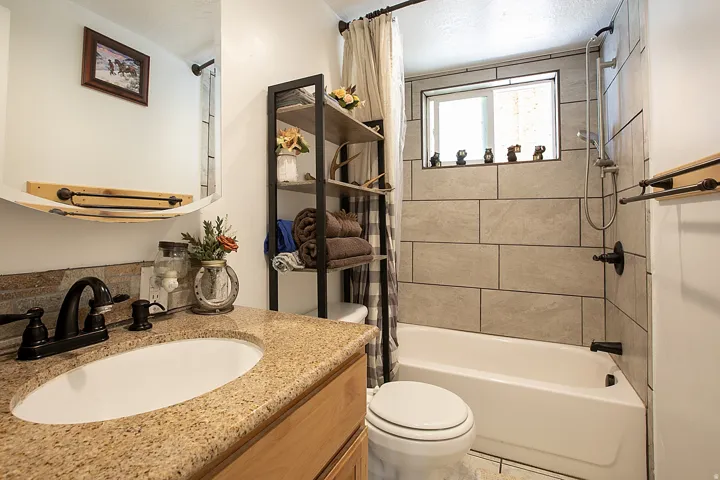 Full bath featuring vanity and shower / tub combo