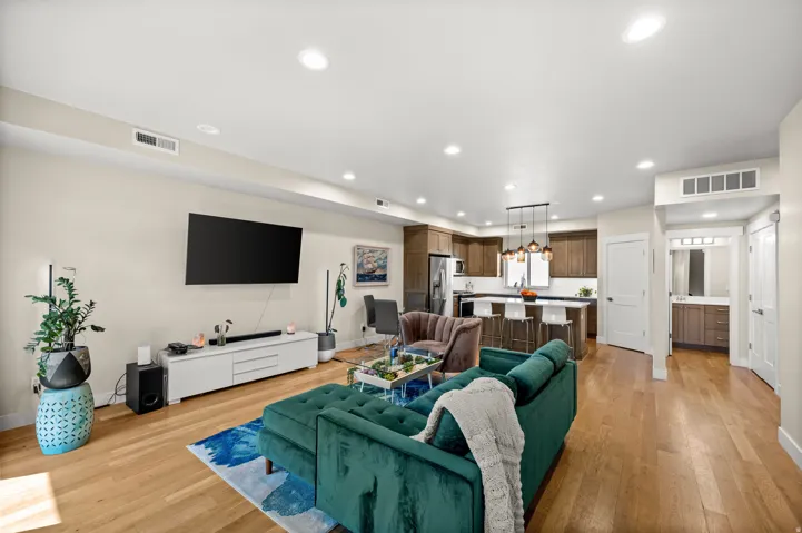 Living area with light wood-style floors and recessed lighting
