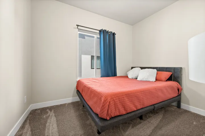 Carpeted bedroom featuring baseboards