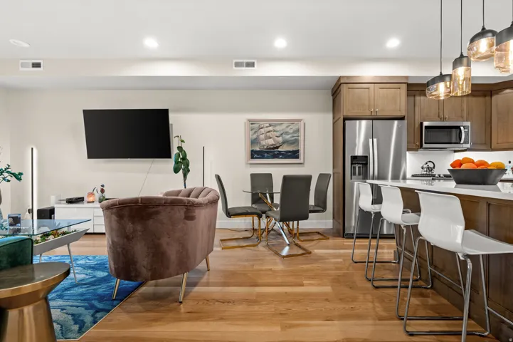 Living area featuring light wood-style flooring and recessed lighting