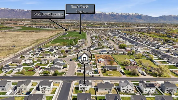 Aerial overview of property's location with nearby suburban area and a mountain backdrop