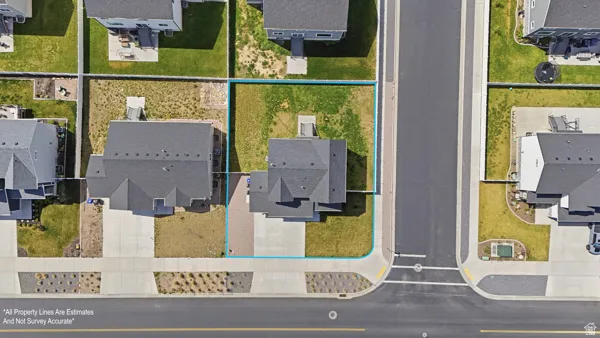 Aerial view of residential area featuring property boundaries highlighted