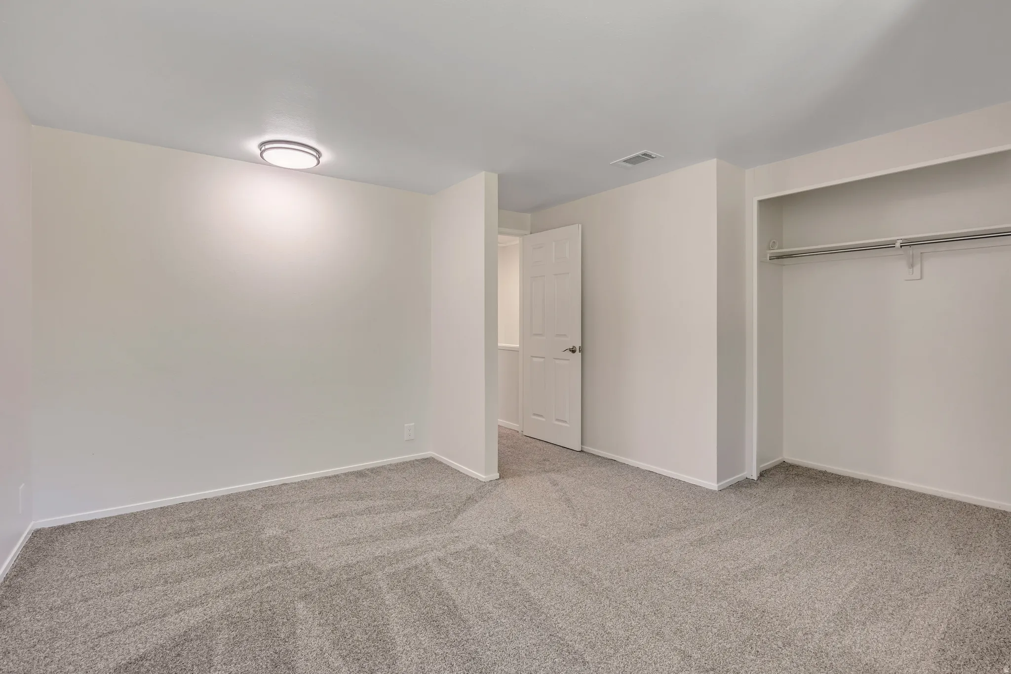 Unfurnished bedroom featuring carpet and a closet