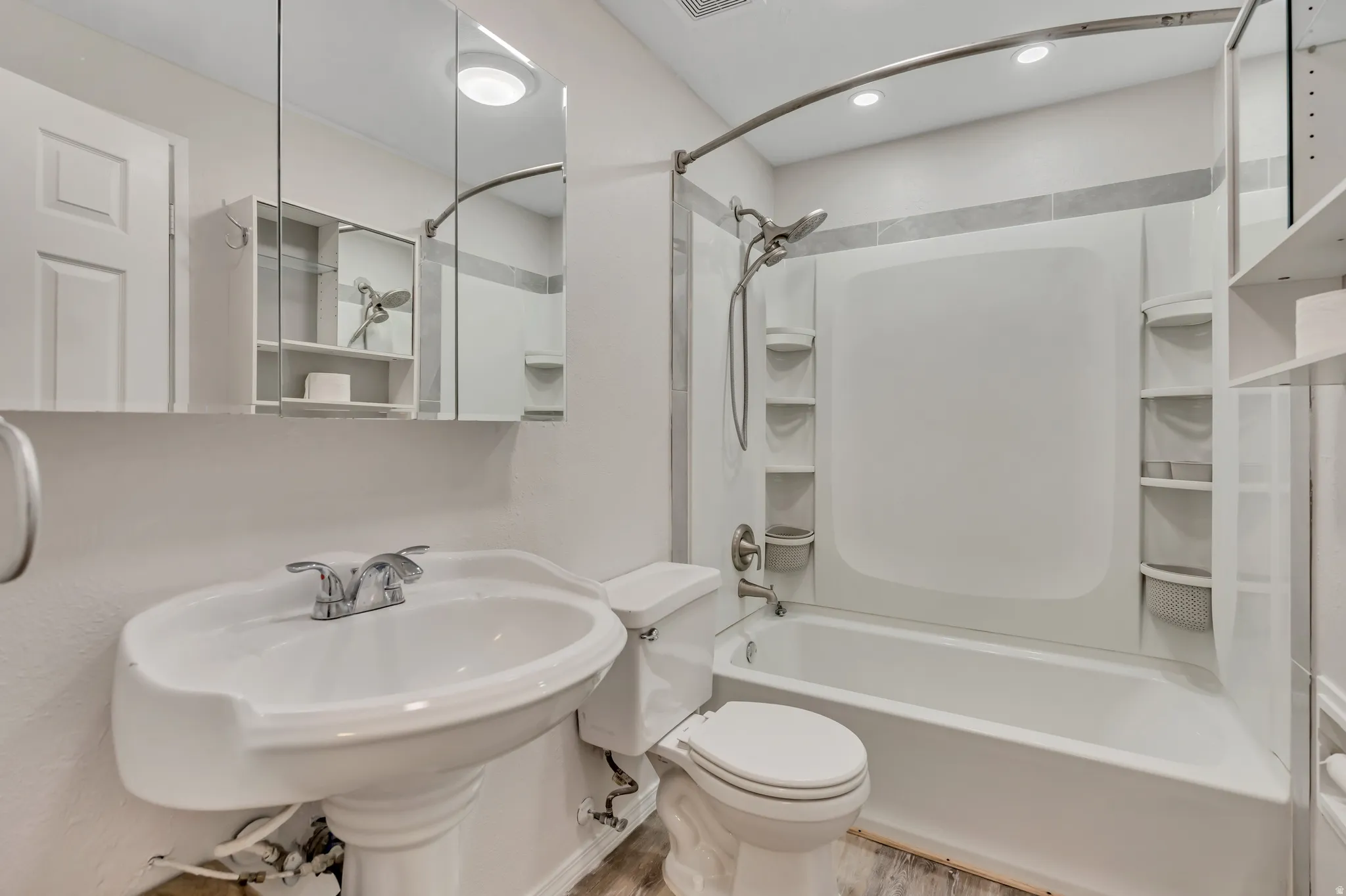 Bathroom featuring shower / bathtub combination, light wood-type flooring, and recessed lighting