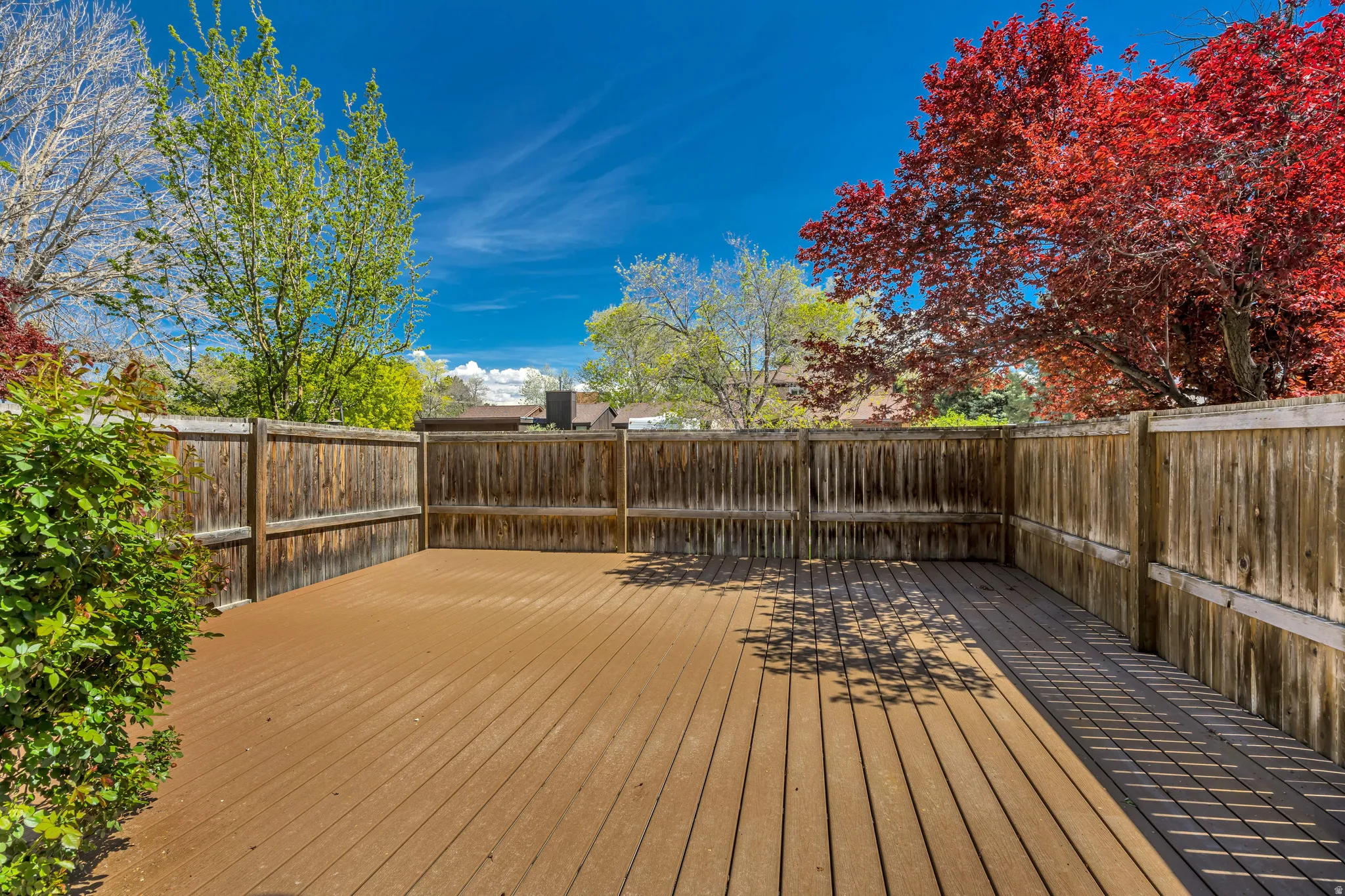 Wooden terrace featuring a fenced backyard