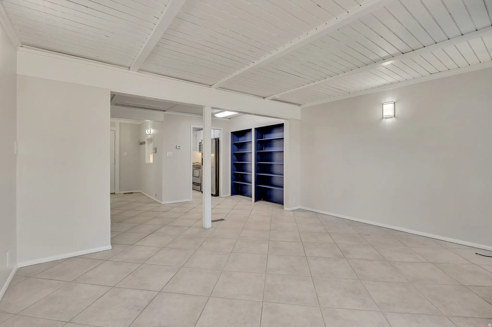 Spare room with light tile patterned flooring and wood ceiling