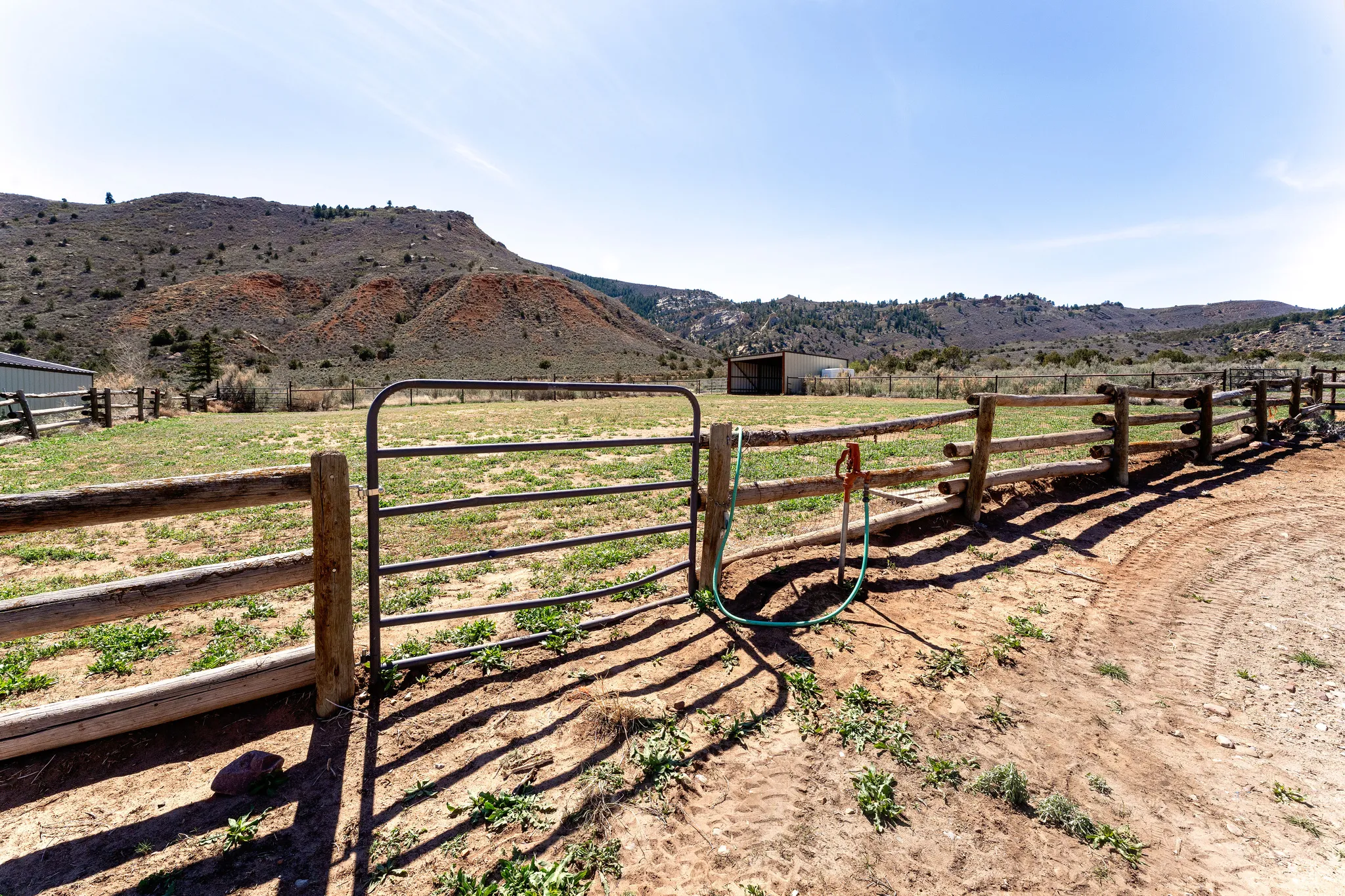 Fenced pasture with gate and hydrant