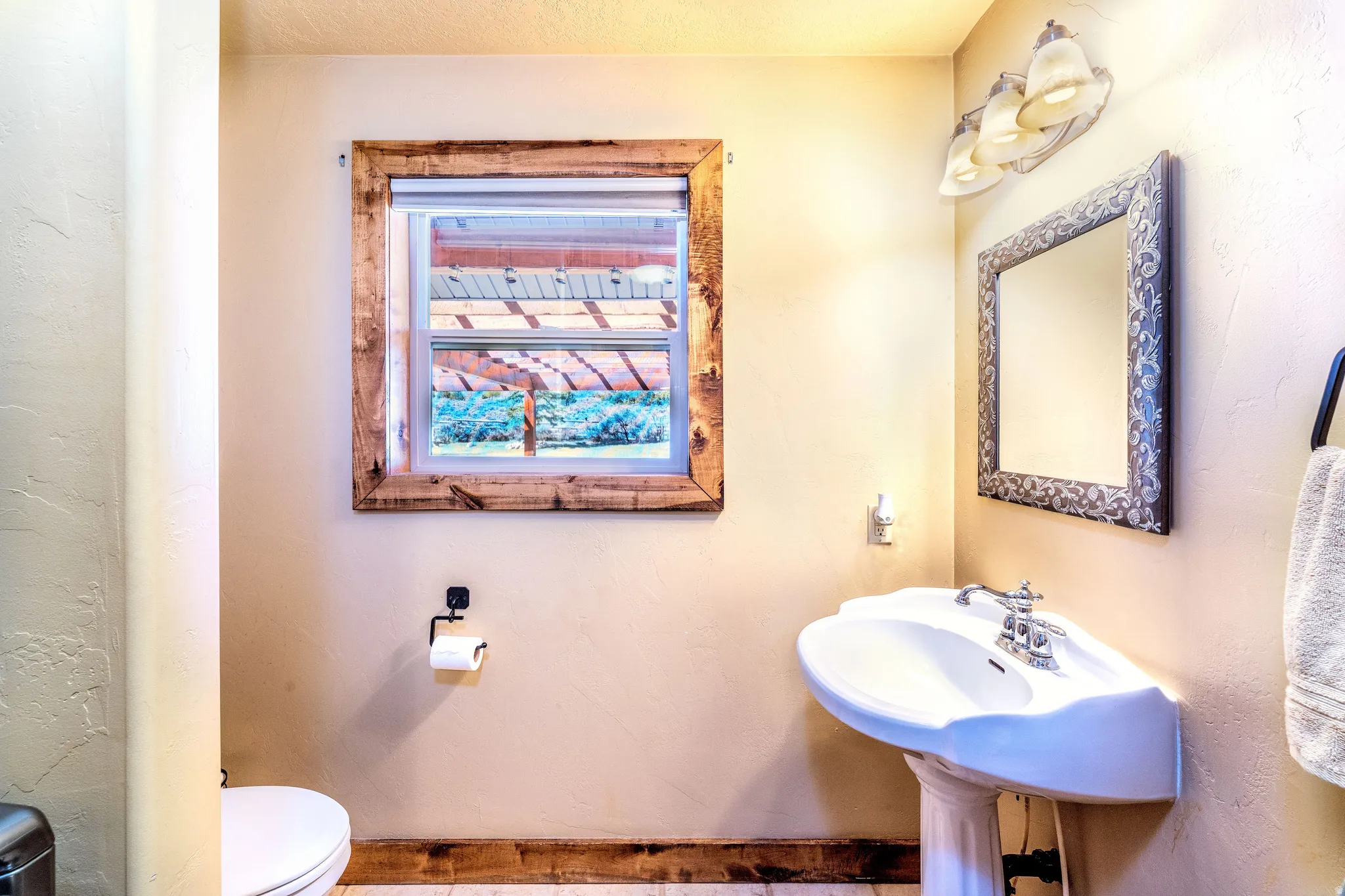 Half bath featuring toilet and a textured wall