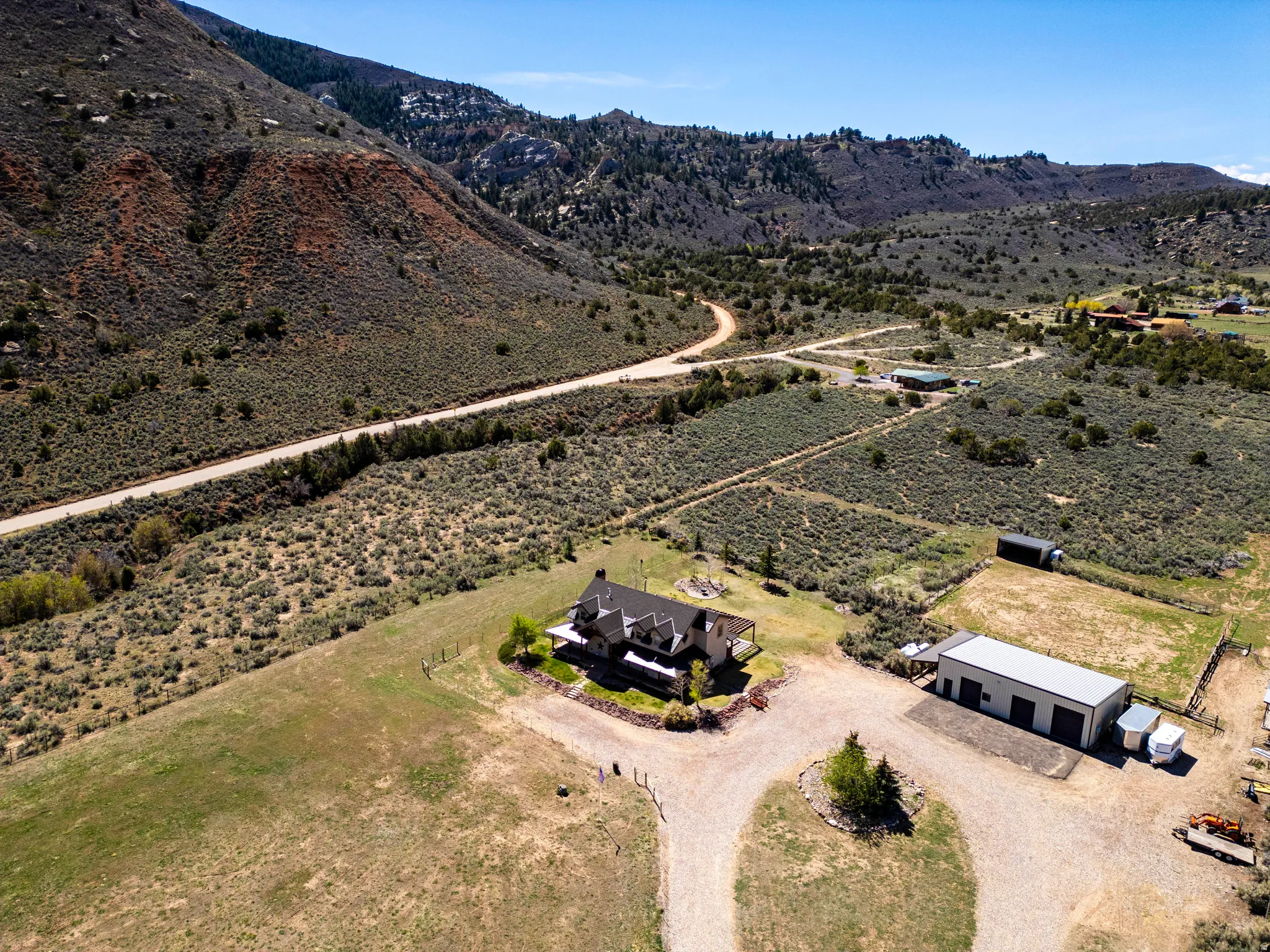 Aerial view of property's location with a mountain backdrop and rural landscape