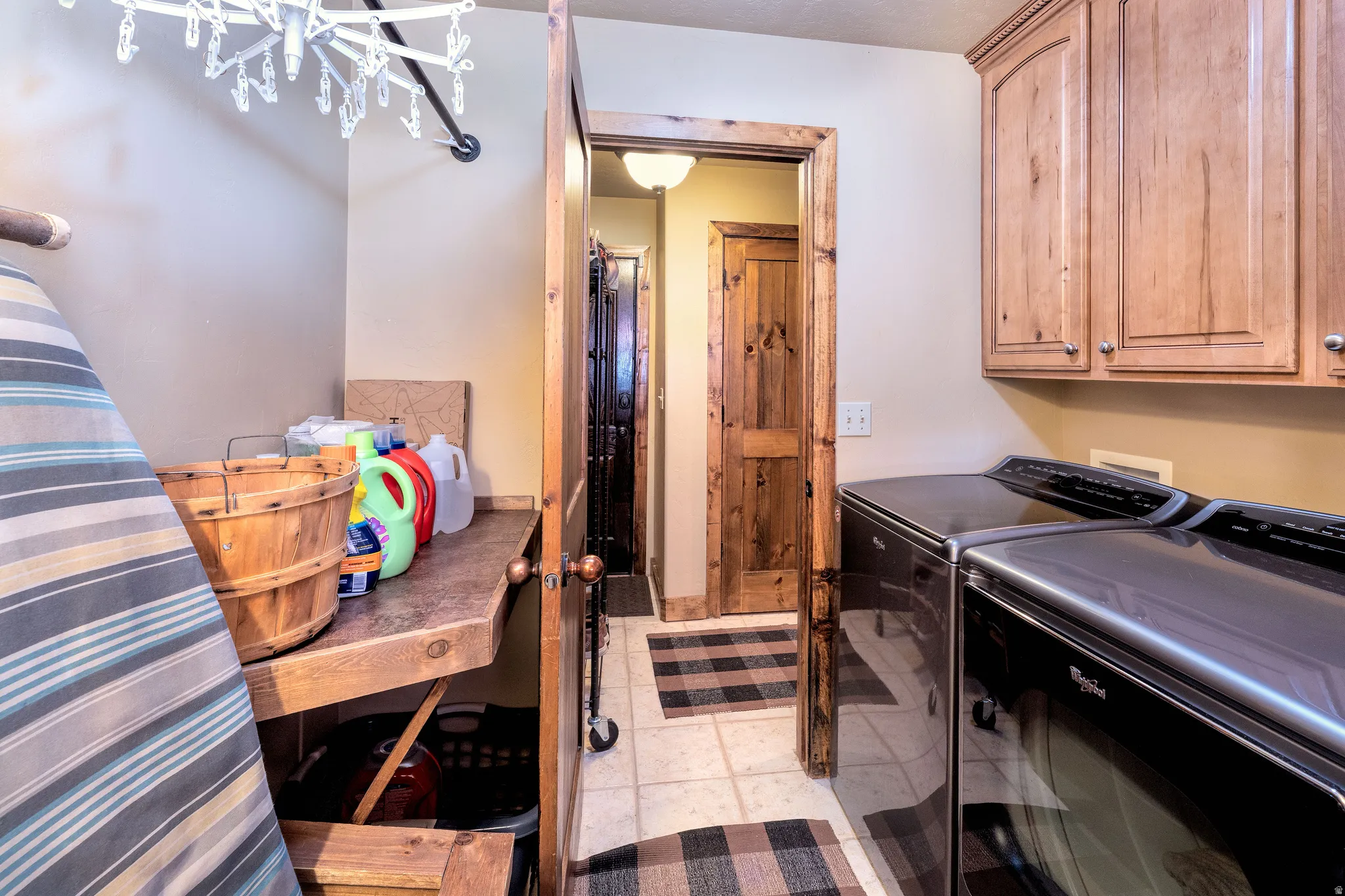 Laundry room featuring washing machine and clothes dryer, cabinet space and counter