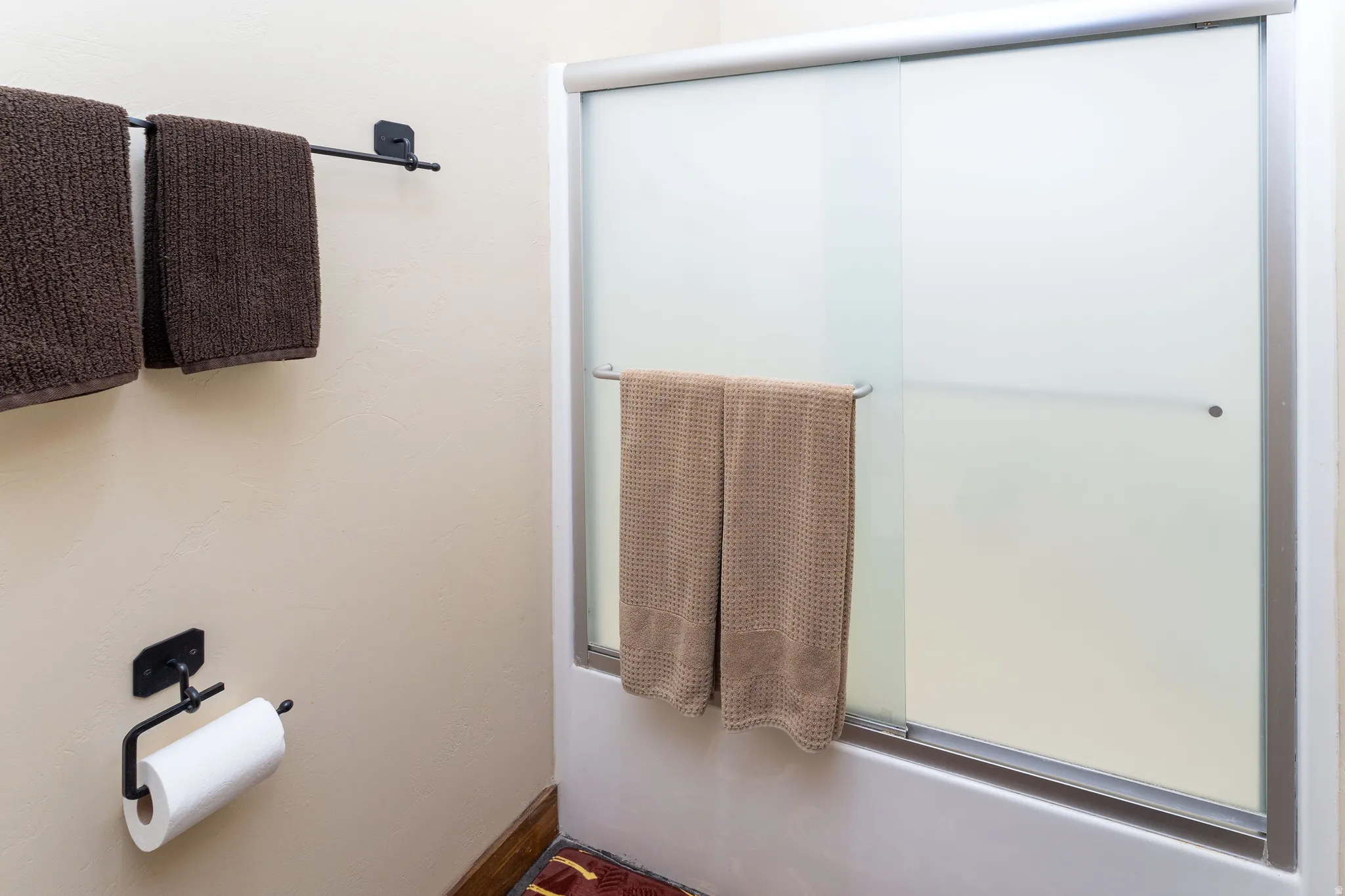 Full bathroom with bath / shower combo with glass door