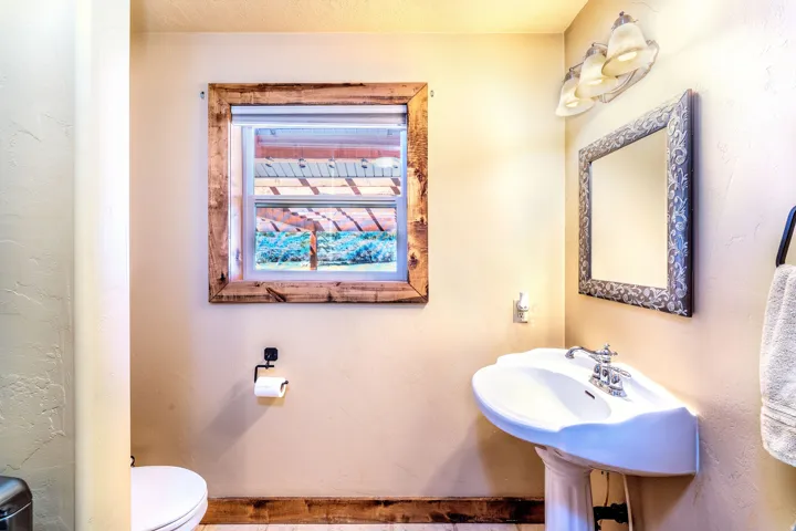 Half bath featuring toilet and a textured wall