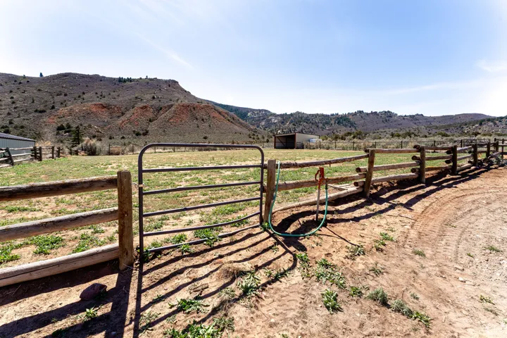 Fenced pasture with gate and hydrant