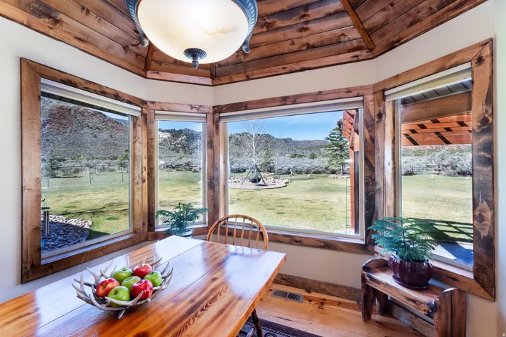 Dining room featuring backyard and gorgeous mountain views. Sit and watch the wildlife!