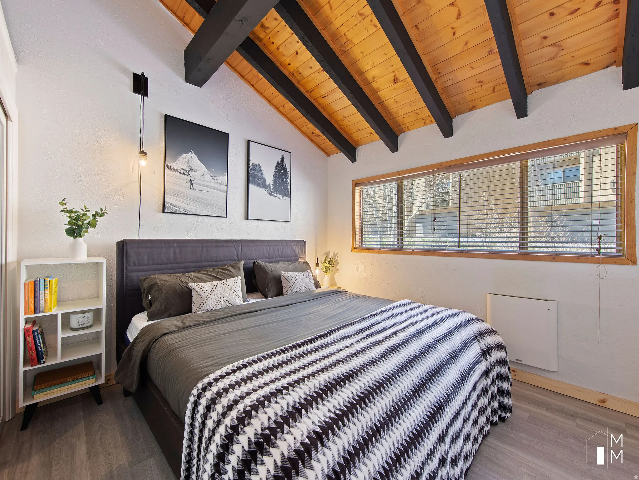 Bedroom featuring vaulted ceiling with beams, wood finished floors, wood ceiling, and heating unit