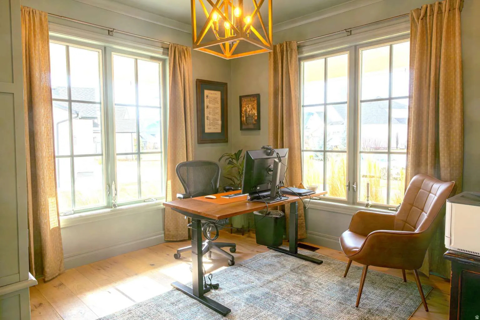 Office area featuring a chandelier, light wood finished floors, and crown molding