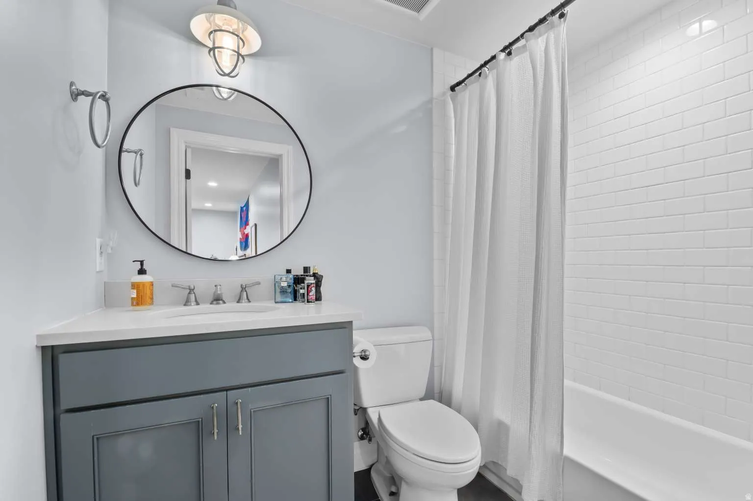 Full bath featuring vanity and shower / bathtub combination with curtain