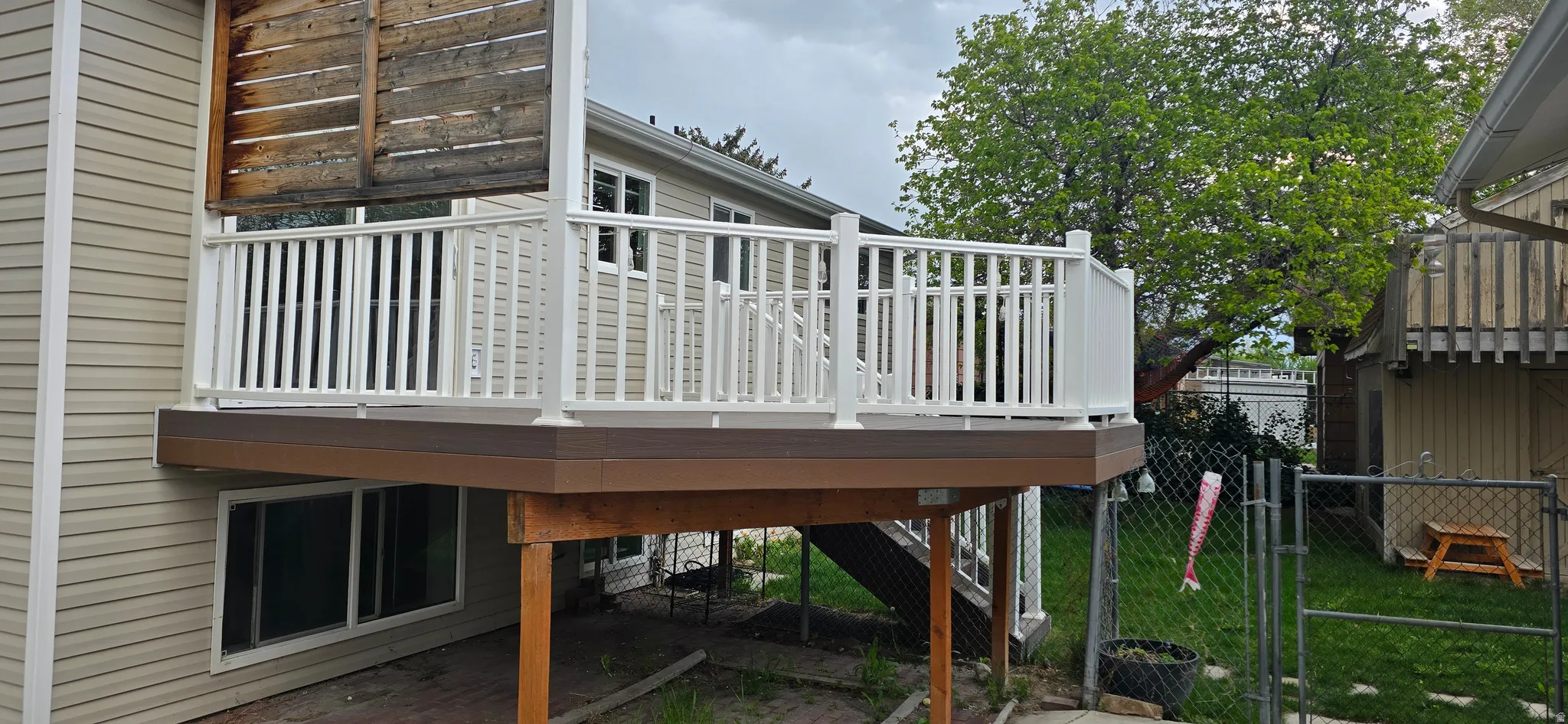 Deck with a gate and a patio