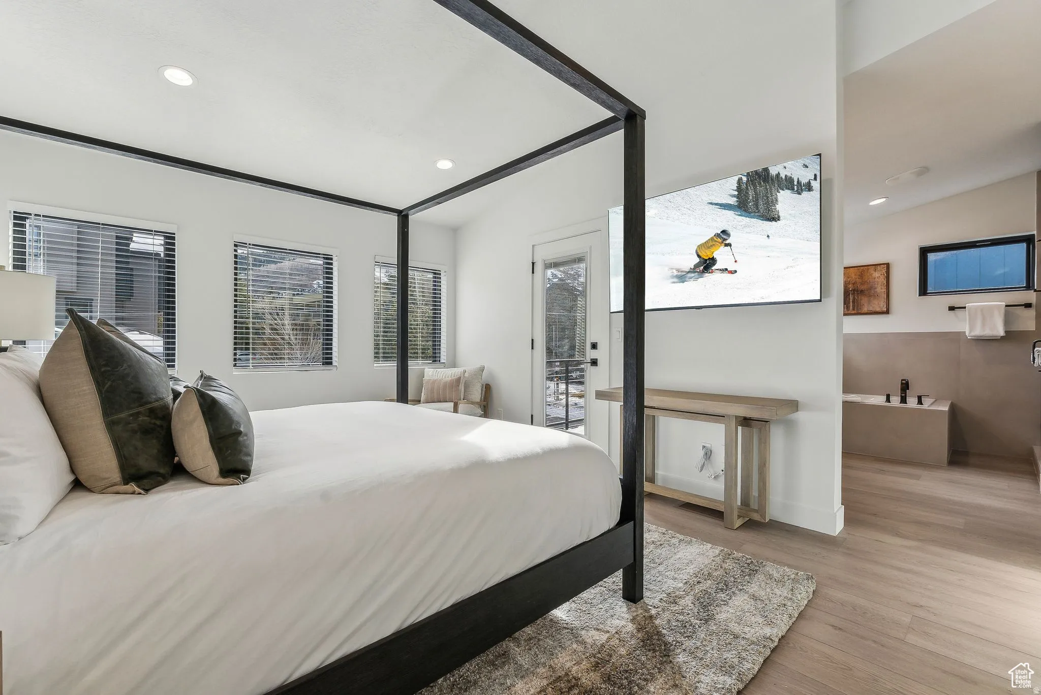 Bedroom with light wood-type flooring, recessed lighting, and access to exterior