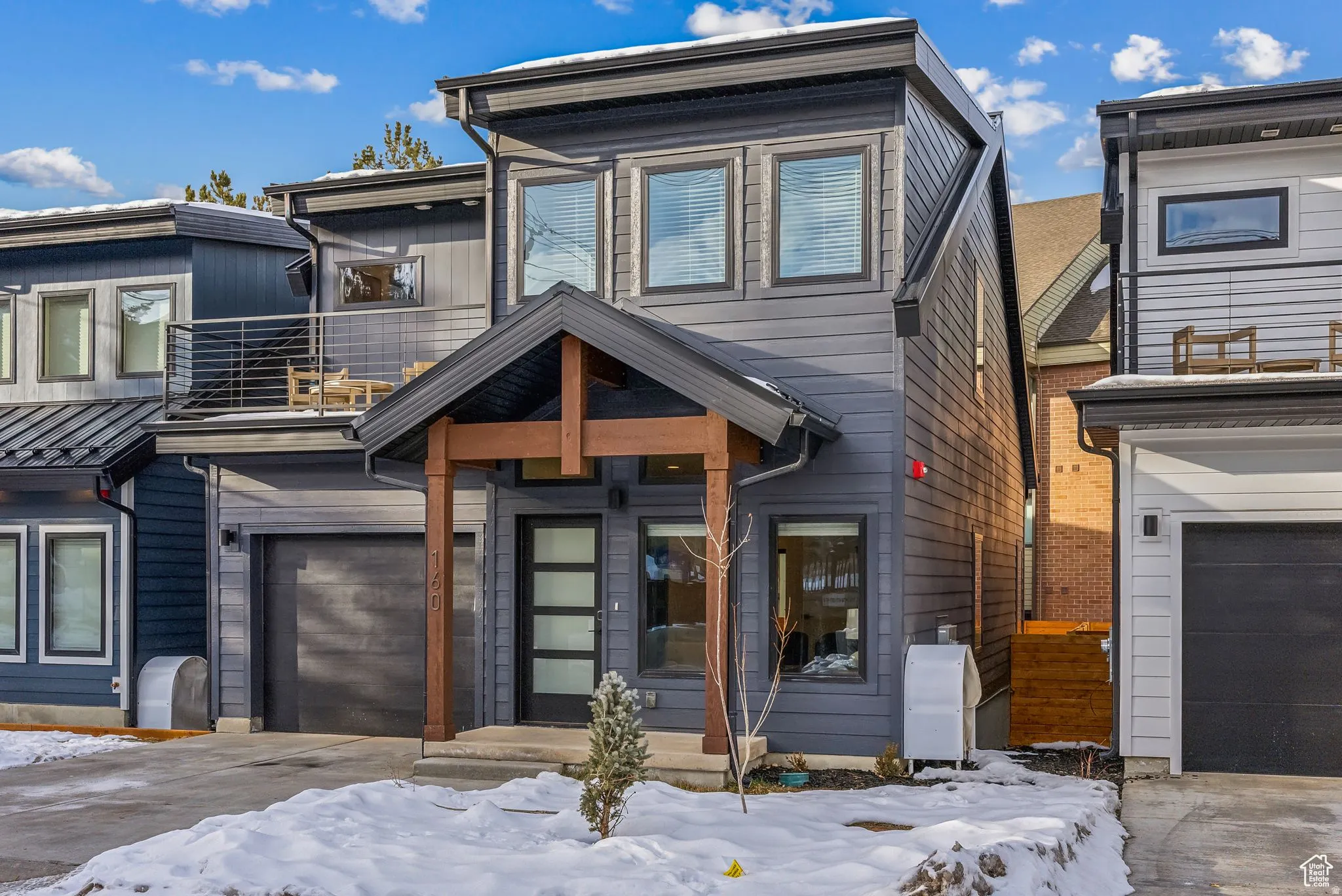 View of front of house featuring a balcony and an attached garage