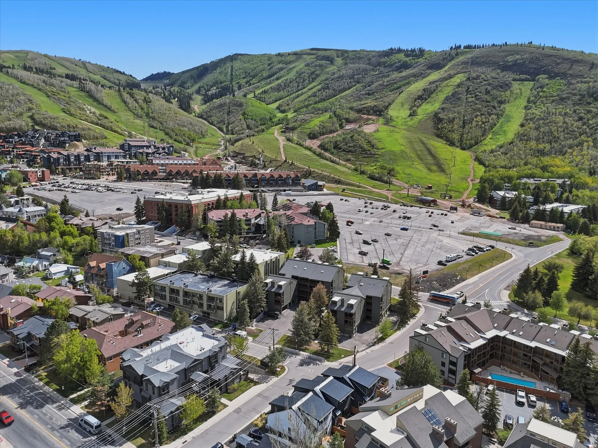 Aerial perspective showcasing a mountain landscape with multiple residential and commercial structures