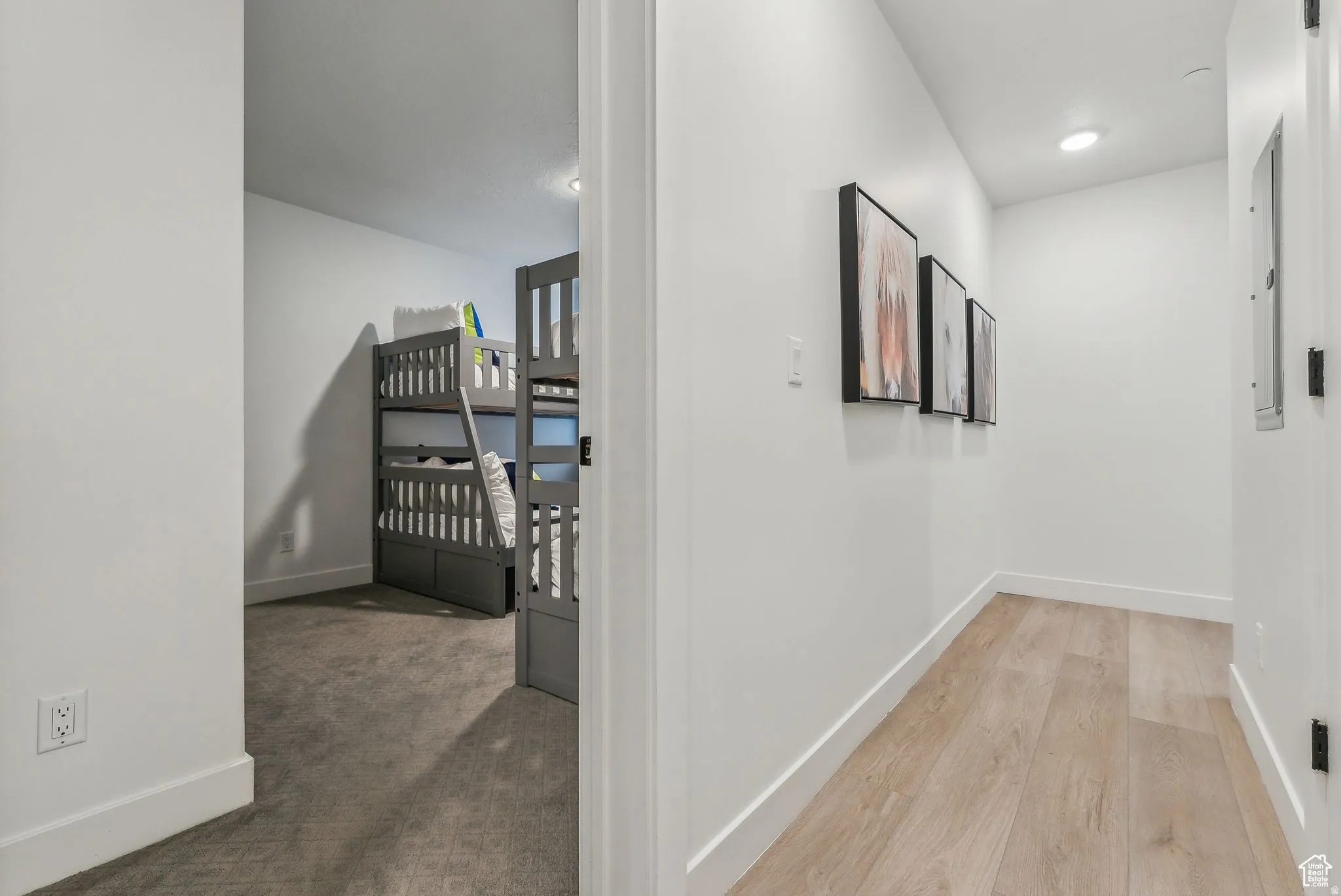 Hallway with light carpet and recessed lighting