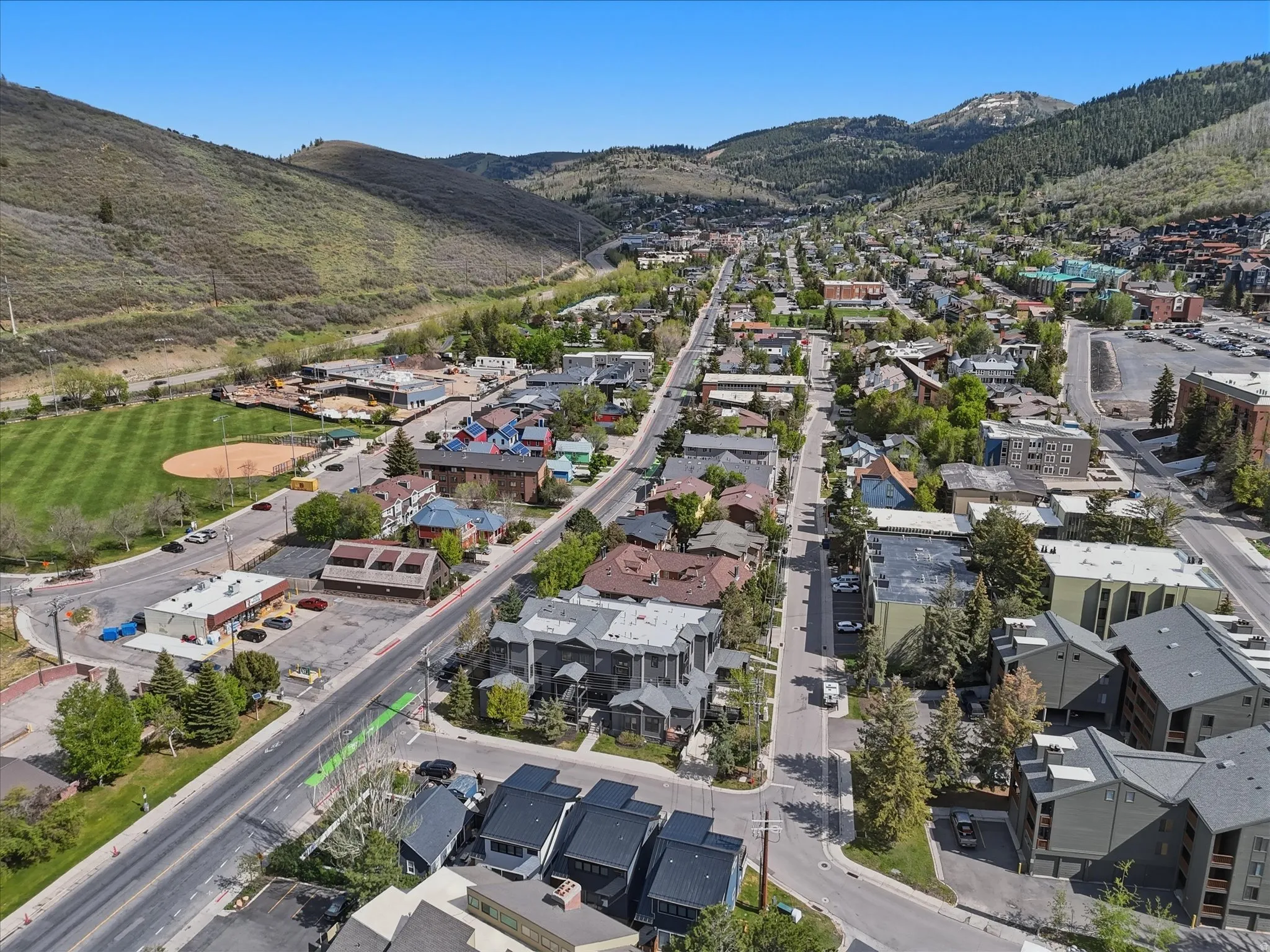 Aerial perspective showcasing a mountain community with residential and commercial structures
