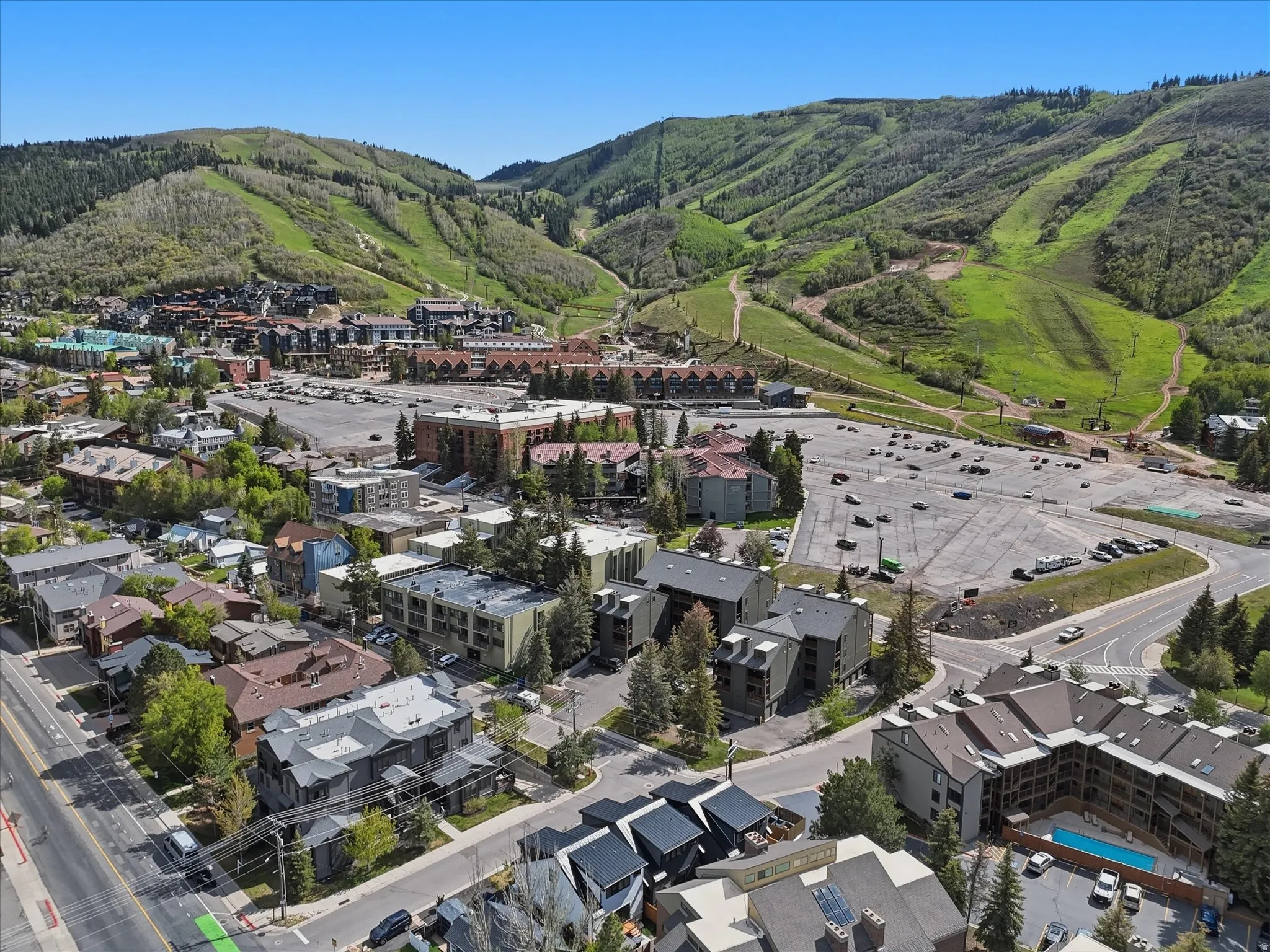 Aerial perspective showcasing a vibrant community nestled against verdant mountainsides