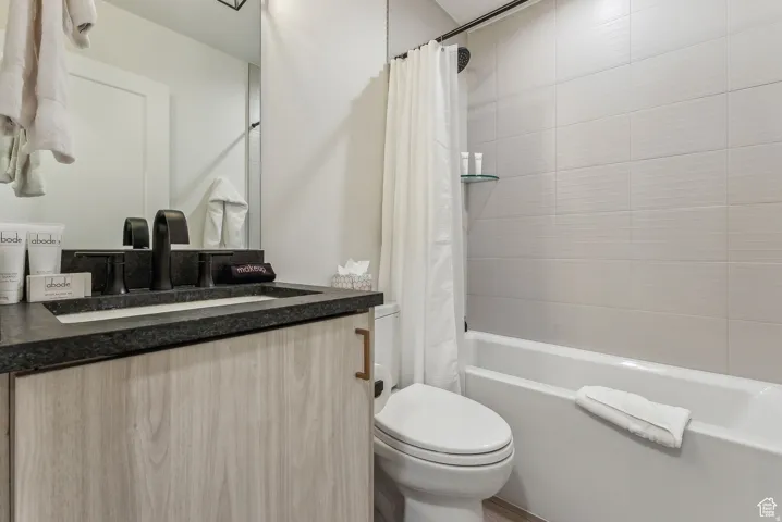 Full bathroom with vanity and shower / bath combination with curtain