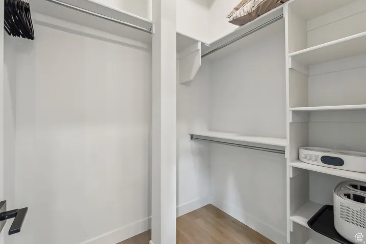 Walk in closet featuring light wood-style floors
