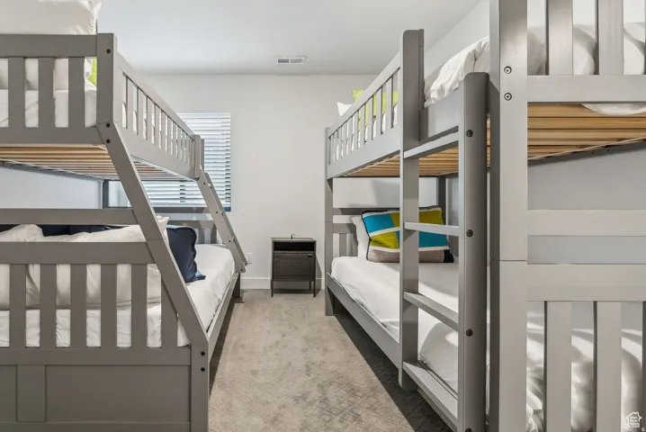 Bedroom with light carpet and baseboards