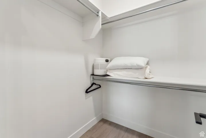 Walk in closet featuring light wood-type flooring