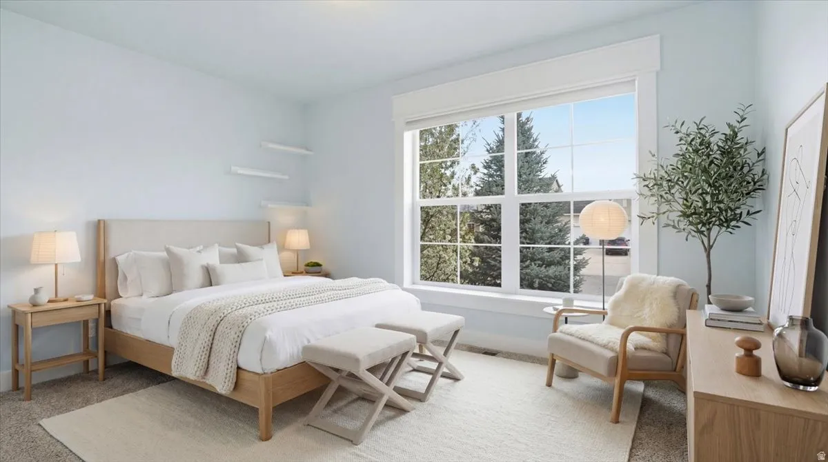 Bedroom featuring baseboards and light carpet