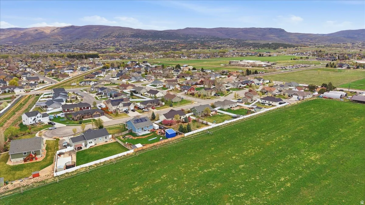 Aerial view of property's location with a mountainous background and nearby suburban area
