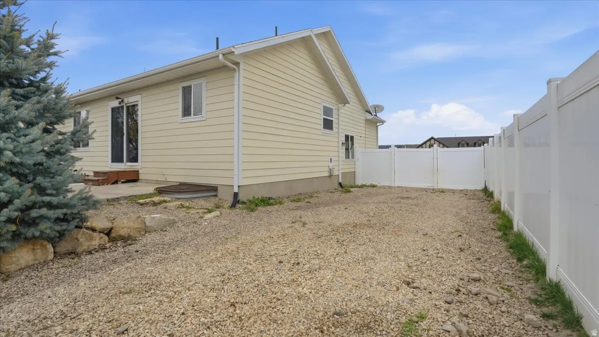 View of home's exterior featuring a fenced backyard and a patio area