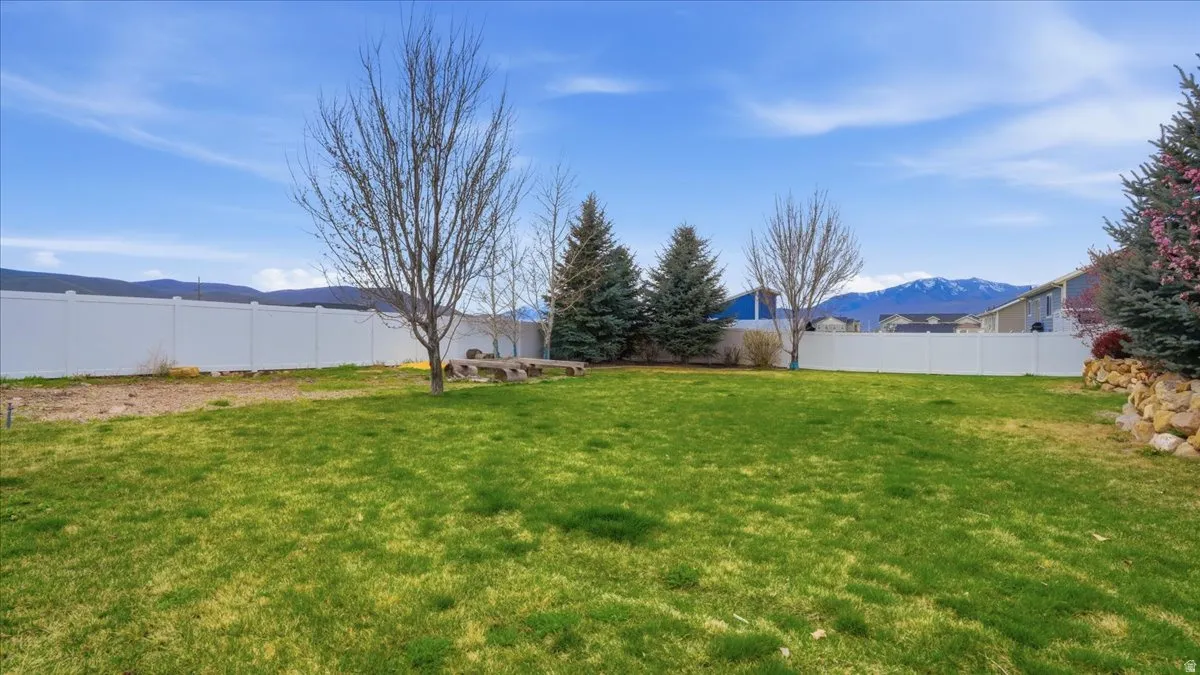 Fenced backyard with a mountain view