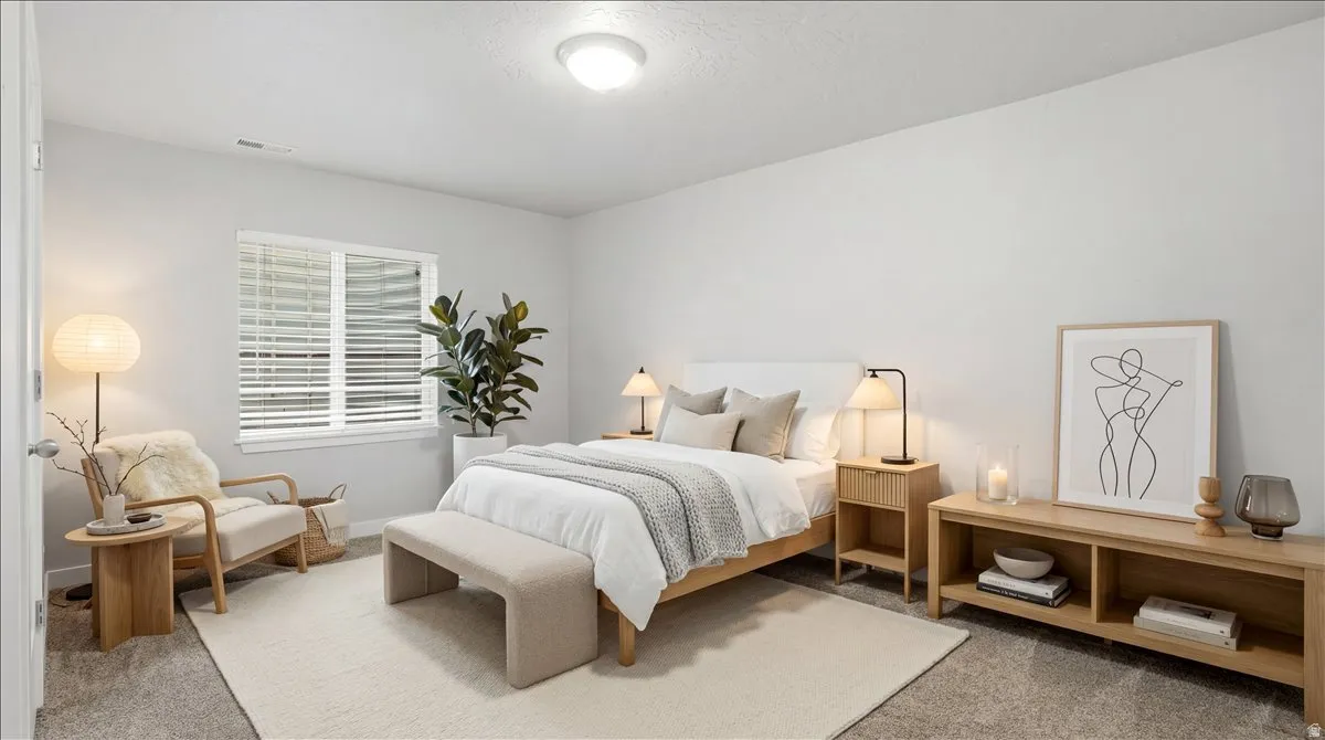 Bedroom with light carpet and baseboards