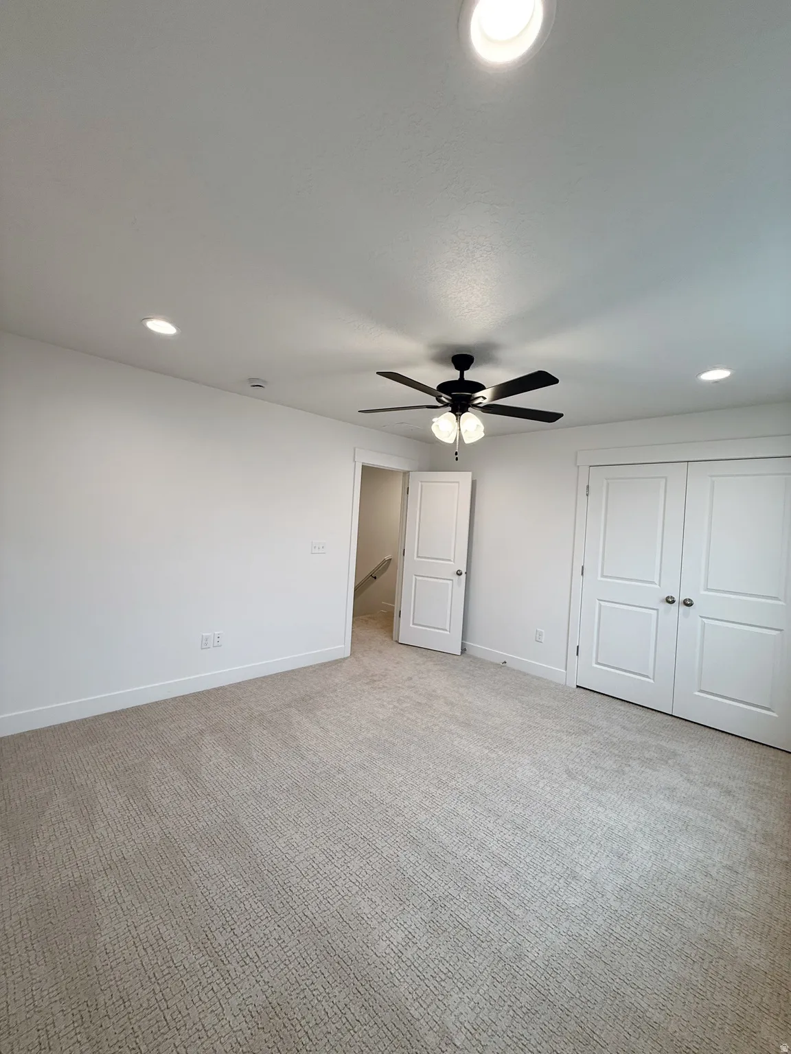 Unfurnished bedroom with recessed lighting, carpet floors, a ceiling fan, and a closetPhotos are for reference only.  Actual finishes may vary.