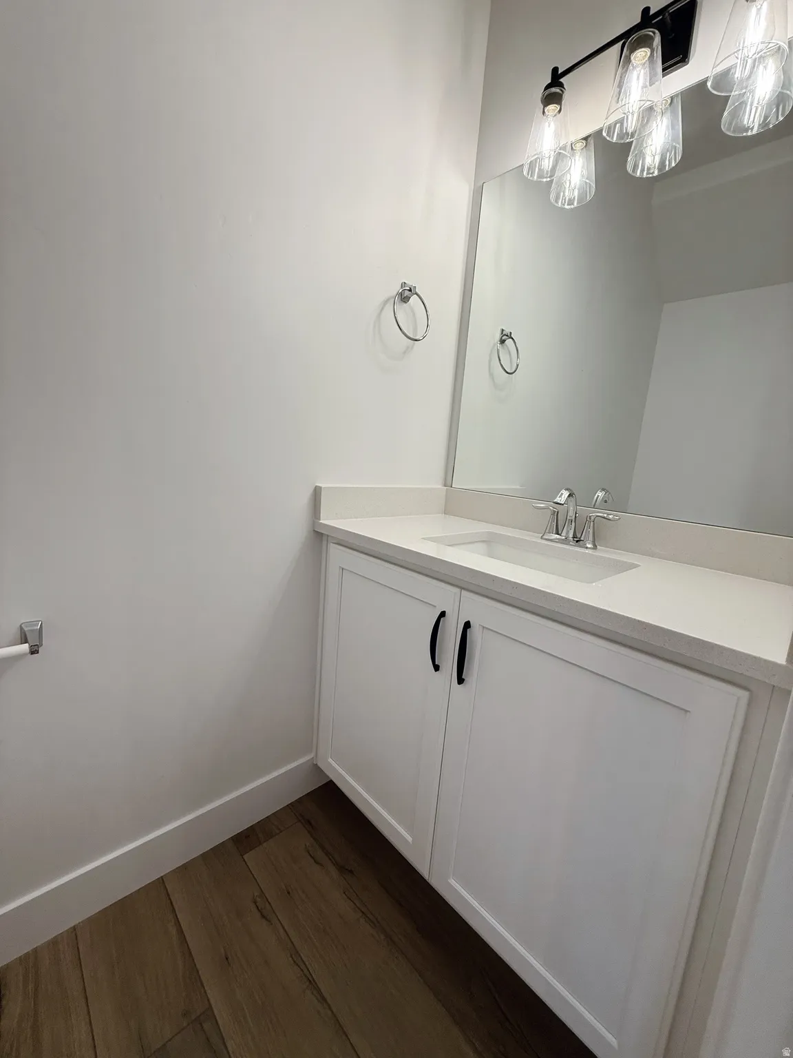 Bathroom featuring dark wood-style flooring and vanityPhotos are for reference only.  Actual finishes may vary.