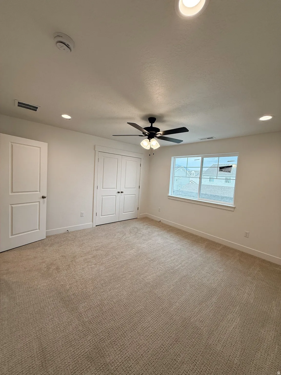 Unfurnished bedroom featuring recessed lighting, a closet, carpet floors, and a ceiling fanPhotos are for reference only.  Actual finishes may vary.