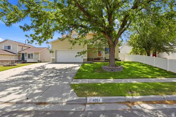 Front of house featuring a beautiful, mature tree and RV parking.
