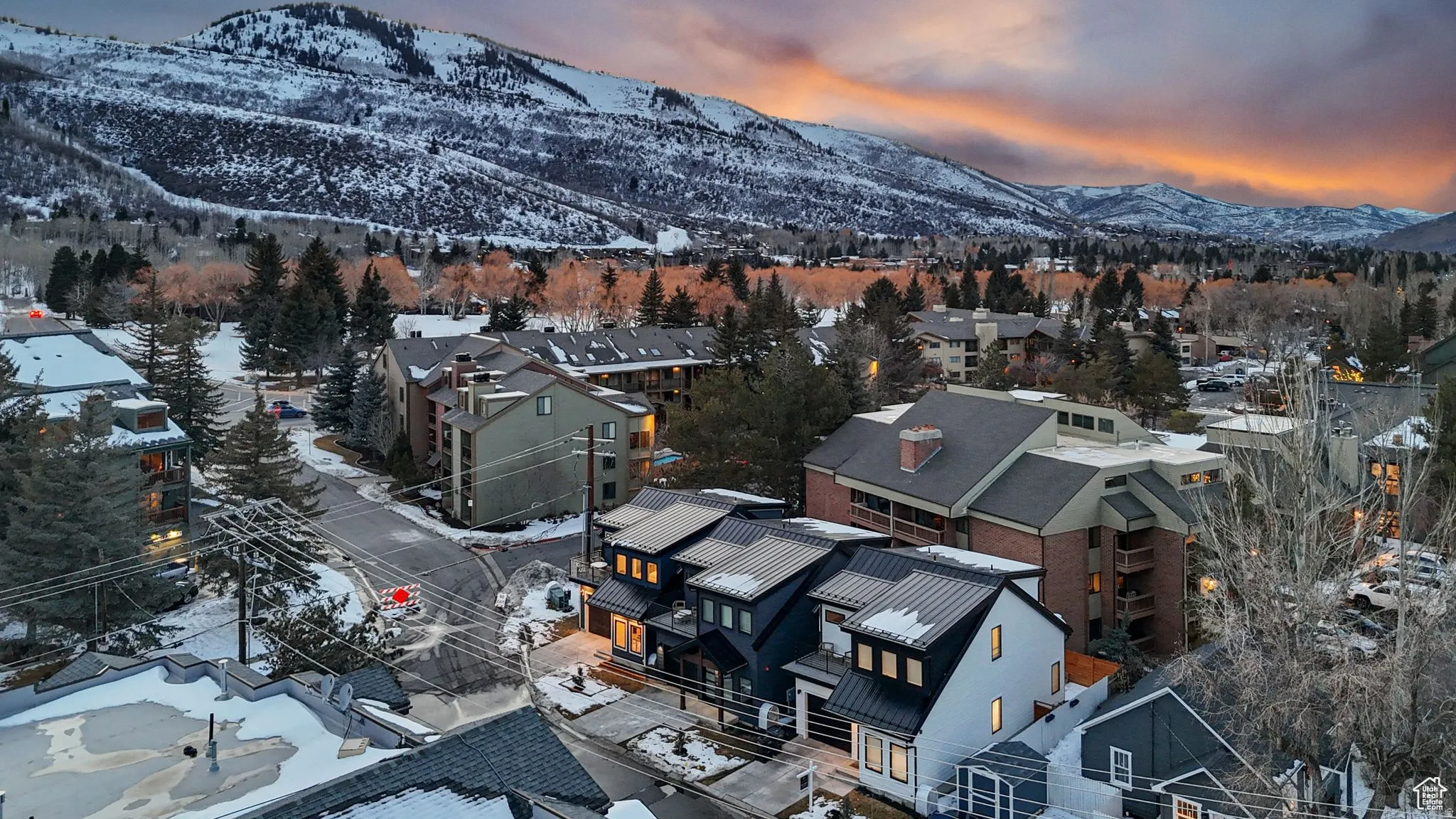Snowy aerial view with a mountain view and a residential view