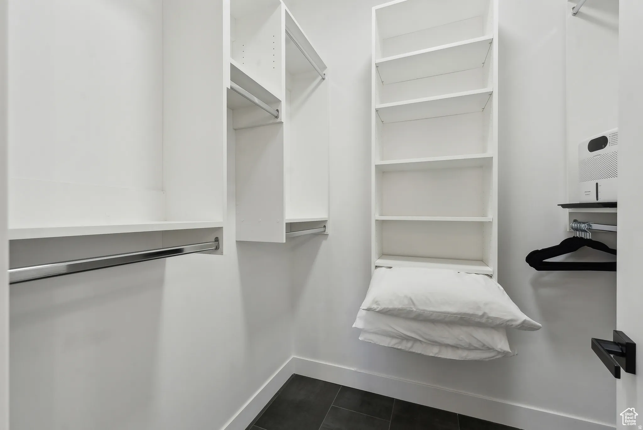 Walk in closet featuring dark tile patterned floors