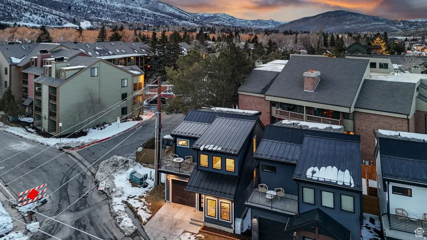 Snowy aerial view with a mountain view and a residential view