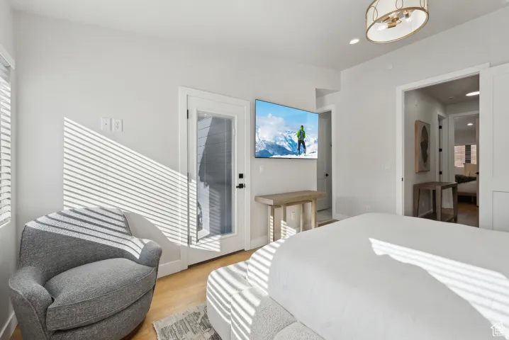 Bedroom featuring light wood finished floors and a chandelier