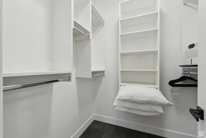 Walk in closet featuring dark tile patterned floors
